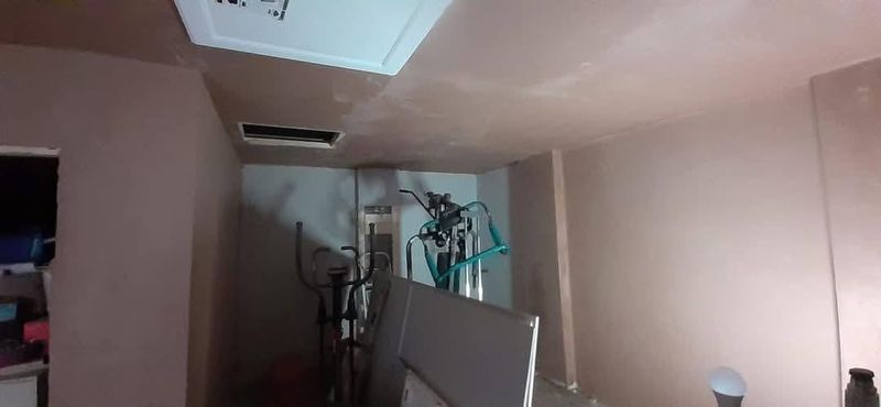 The gym side of the garage plastered